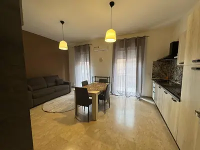 a living room with a table and chairs and a couch at St Joseph in Terrasini