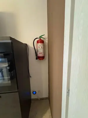 a fire hydrant is on the wall next to a refrigerator at St Joseph in Terrasini
