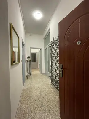 a hallway with a wooden door and a room with a hallway at Pretty Holiday House in Palermo