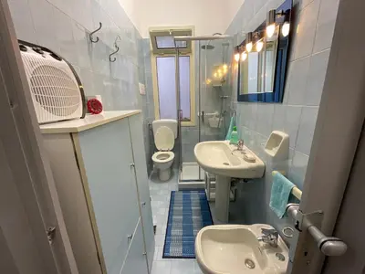 a small bathroom with a sink and a toilet at Pretty Holiday House in Palermo