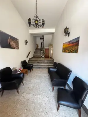 a living room with black chairs and a staircase at Terrasini downtown City Life in Terrasini
