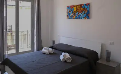 a bedroom with a bed with towels on it at Terrasini downtown City Life in Terrasini