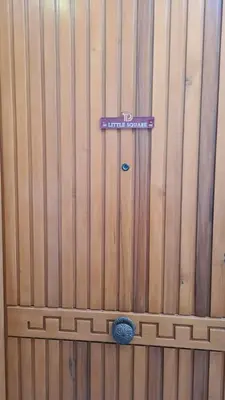 a wooden fence with a purple sign on it at Terrasini Downtown Little Square in Terrasini