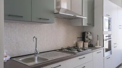 a kitchen with a sink and a stove at Terrasini Downtown Little Square in Terrasini