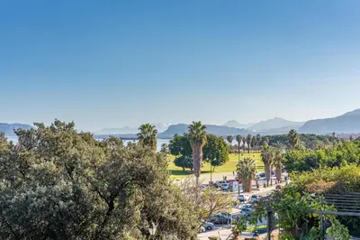 a park with palm trees and a parking lot at La Casa al Foro Vista Mare by Wonderful Italy in Palermo