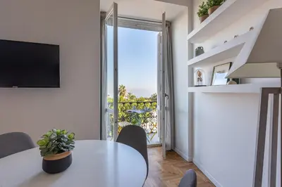 a white dining room with a table and a window at La Casa al Foro Vista Mare by Wonderful Italy in Palermo