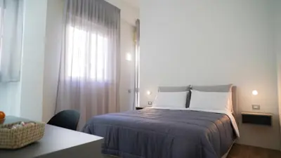 a small bedroom with a bed and a window at Harbour Front - Luxury Rooms in Palermo