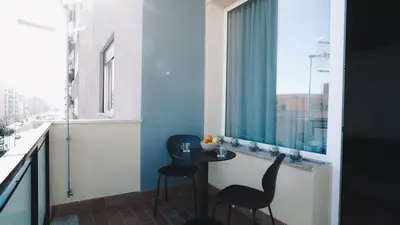 a room with a table and two chairs and a window at Harbour Front - Luxury Rooms in Palermo