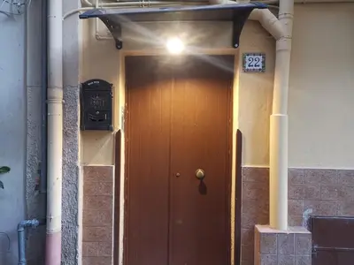 a brown door with a light on top of it at Primo Piano in Palermo