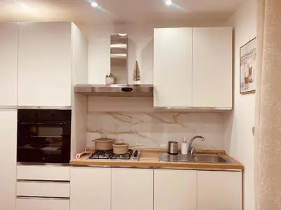 a kitchen with white cabinets and a sink at Primo Piano in Palermo
