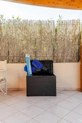 a black box sitting on a tiled floor with a fireplace at Villa Rossa by Sicily Travelling Villas in Scopello