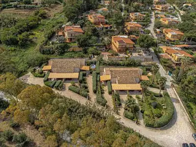 an aerial view of a village with houses and trees at Villa Rossa by Sicily Travelling Villas in Scopello