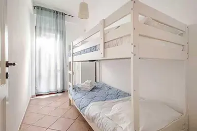 a bedroom with two bunk beds in a room at Villa Rossa by Sicily Travelling Villas in Scopello