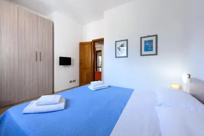a kitchen and living room with a table and chairs at Trilocale Piano Terra Con Veranda in San Vito lo Capo