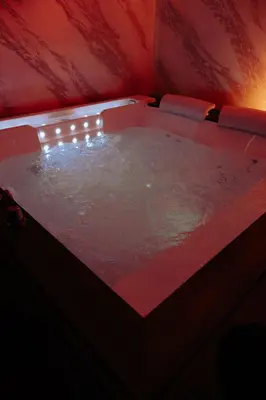 a large hot tub in a red room with at Papireto Rooms in Palermo