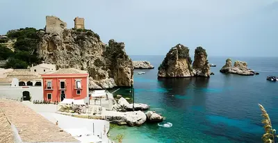 a view of the amalfi coast with a red building at Villa Disa by Sicily Travelling Villas in Castellammare del Golfo