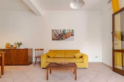 a living room with a yellow couch and a table at Villa Disa by Sicily Travelling Villas in Castellammare del Golfo