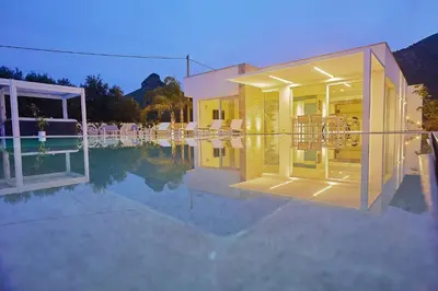 a house with a swimming pool in front of it at Villa the Twins in Castellammare del Golfo