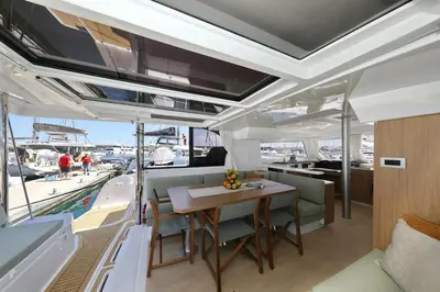 a dining area of a boat with a table and chairs at Sicily by Catamaran in Palermo