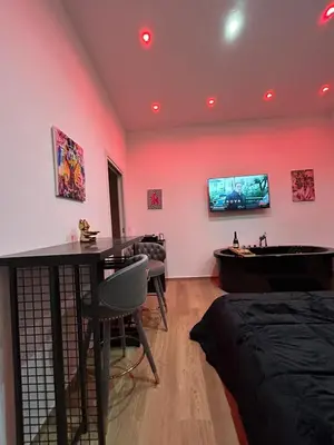 a room with a table and a bathtub and a bedroom at Sweet dreams in Palermo