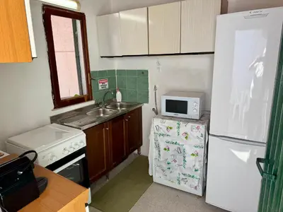 a small kitchen with a sink and a refrigerator at Villa Pino in Carini
