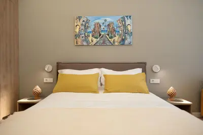 a bedroom with a large bed with yellow pillows at Quattro Canti Deluxe in Palermo
