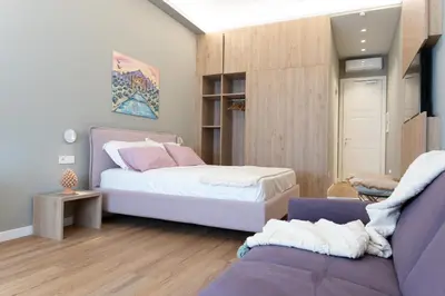 a bedroom with a bed and a couch at Quattro Canti Deluxe in Palermo