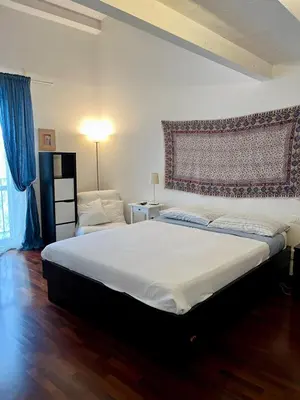 a bedroom with a large bed with a large headboard at Casa Vacanze Sfera 6 in Palermo