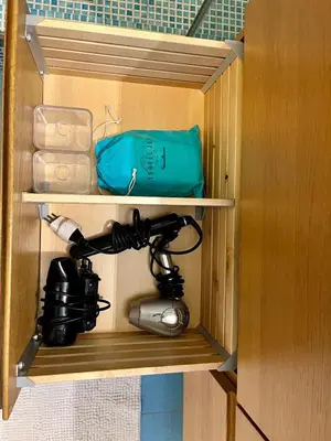 a cupboard with a camera and a bag at Casa Vacanze Sfera 6 in Palermo