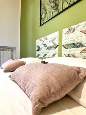 a bed with two pillows on top of it at Balat City in Palermo