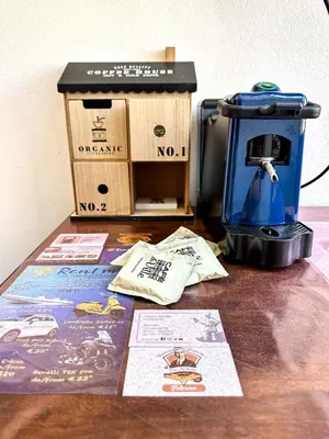 a coffee maker and boxes on a wooden table at Balat City in Palermo