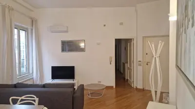 a living room with a couch and a television at Brunetto House in Palermo