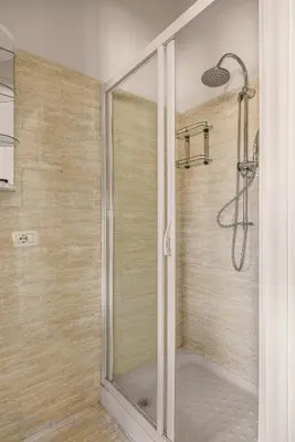 a shower with a glass door in a bathroom at Chez Gabriel by DomuSicily in Palermo