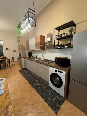 a kitchen with a refrigerator and a washing machine at Suli D'amuri in Palermo