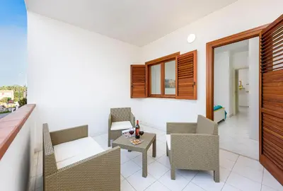 a living room with chairs and a table at Trilocale Mulino Superior in San Vito lo Capo