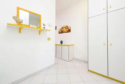 a room with white walls and a mirror at Trilocale Mulino Superior in San Vito lo Capo