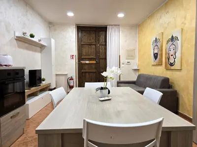a kitchen and living room with a table and chairs at Maison Cattedrale - Proppro SRL - Palermo in Palermo