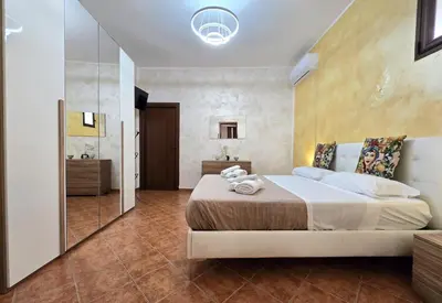 a bedroom with a large bed and a mirror at Maison Cattedrale - Proppro SRL - Palermo in Palermo