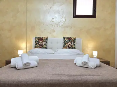 a bedroom with a large bed with towels on it at Maison Cattedrale - Proppro SRL - Palermo in Palermo