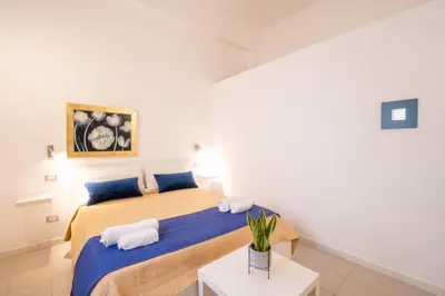 a bedroom with a bed with two pillows on it at Opera Suite in Castellammare del Golfo