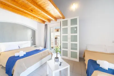 a bedroom with two beds and a window at Opera Suite in Castellammare del Golfo