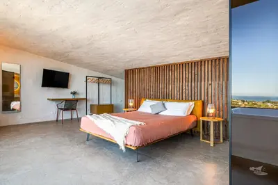 a bedroom with a large bed and a table at Villa Brezza in Partinico