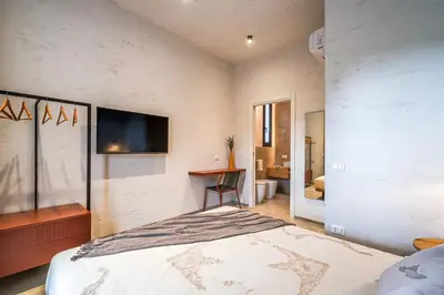 a bedroom with a bed and a tv on the wall at Villa Armonia in Partinico