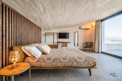 a bedroom with a large bed and a table at Villa Armonia in Partinico