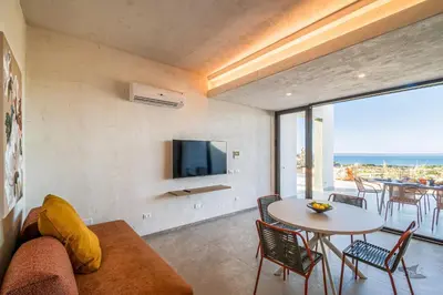 a living room with a couch and a table with chairs at Villa Armonia in Partinico