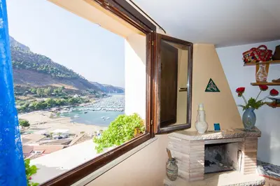 a room with a window with a view of the ocean at Dimore Barraco - SiciliaDaMare in Castellammare del Golfo