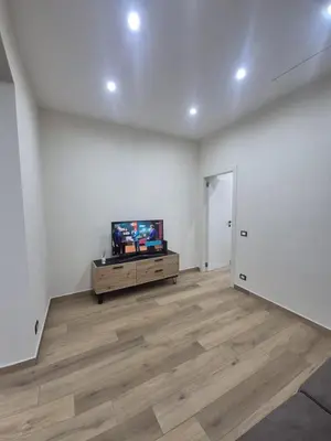 an empty living room with a flat screen tv at Trinacria Guest house in Palermo