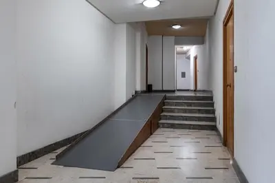 a long hallway with stairs and a ramp in a building at GuestHost - Sicilian Dream - Modern Central Apartment in Palermo