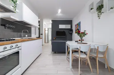 a kitchen with a table and chairs in a kitchen at GuestHost - Sicilian Dream - Modern Central Apartment in Palermo