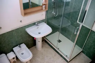 a bathroom with a sink and a shower and a toilet at la casa di Tati Palermo centro in Palermo